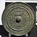 Bronze mirror with designs of buildings