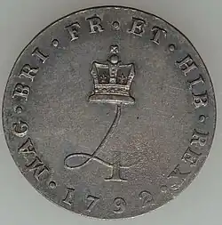 Silver coin with a design featuring a crowned numeral