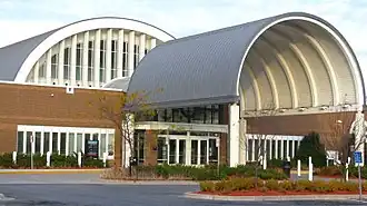 Eden Prairie Library, a brick building with a huge semicircular gray metal covering over its entryway, pictured in 2011