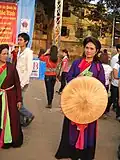 A Quan họ female artist holding a nón quai thao at Lim festival, 2010