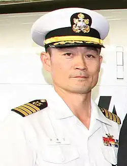 Republic of Korea Navy (ROKN) Captain Yang Yong-mo, wearing a plastic name tag showing his full name in Korean and last name in English