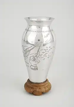 Photograph of a vase made from part of a US plane shot down over Vietnam in 1969 and given to Dr Madeleine Sharp as a representative of the City of Coventry by Nguyễn Thị Bình.