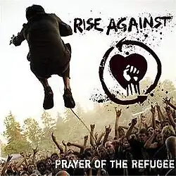 The back of a man is seen while he is jumping in front of a crowd. To the right of the man, there is a drawing of a fist in front of a heart, with the text "RISE AGAINST" above it. In the lower right corner, the text "PRAYER OF THE REFUGEE" is displayed.